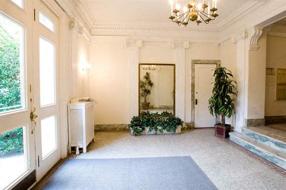 a large room with a large window and a blue rug