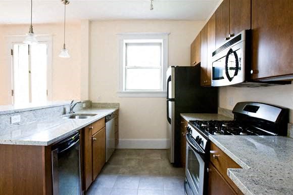 a kitchen with a stove refrigerator and a sink
