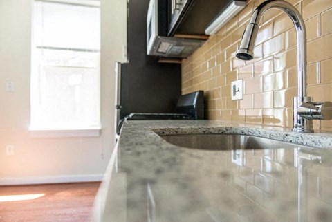 a kitchen with a sink and a microwave
