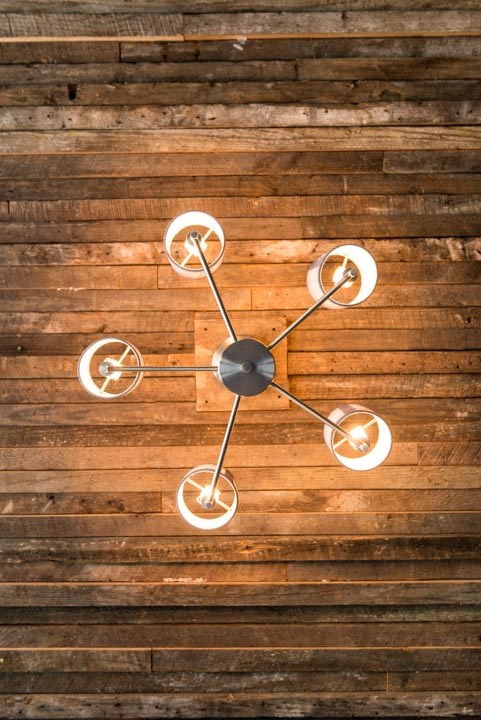 a clock hanging on a wooden wall