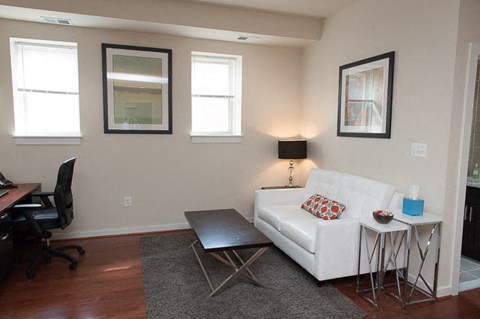 a living room with a white couch and a table