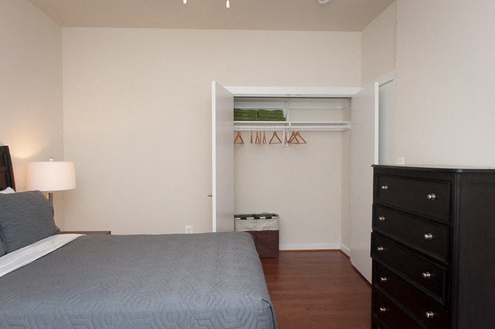 a bedroom with a bed and a dresser