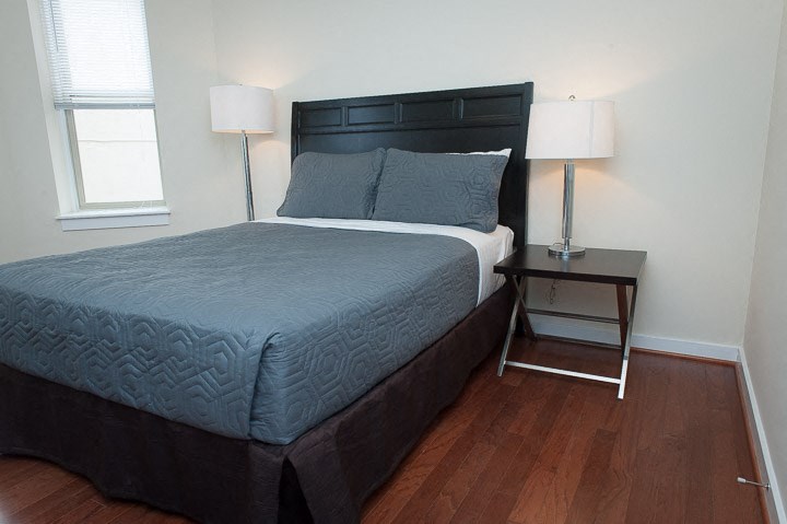 a bedroom with a bed and a nightstand