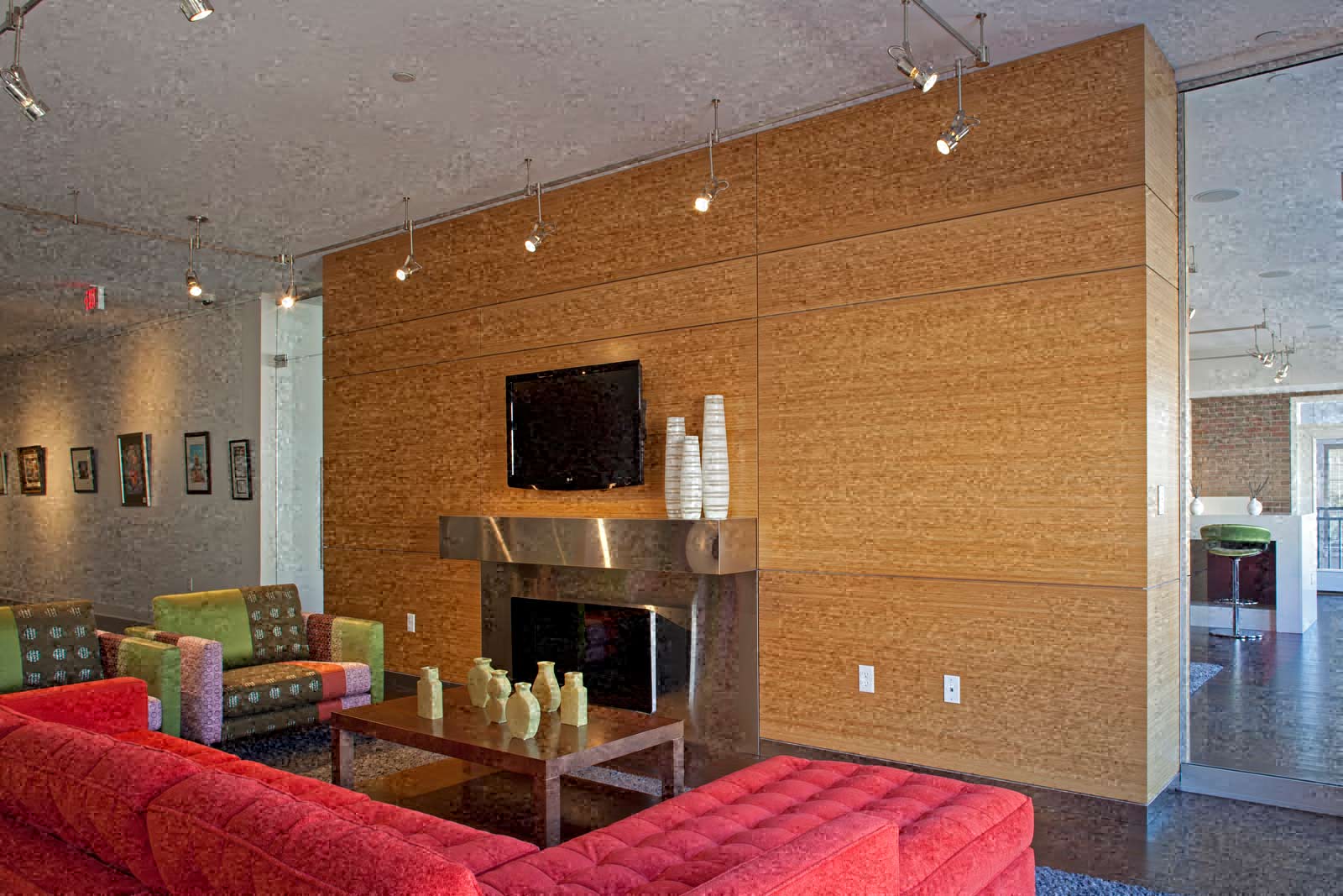 a living room with a red couch and a fireplace