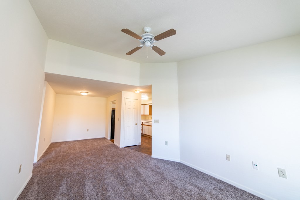 Carpeted living room with ceiling fan at Bradford Run in Kokomo, IN