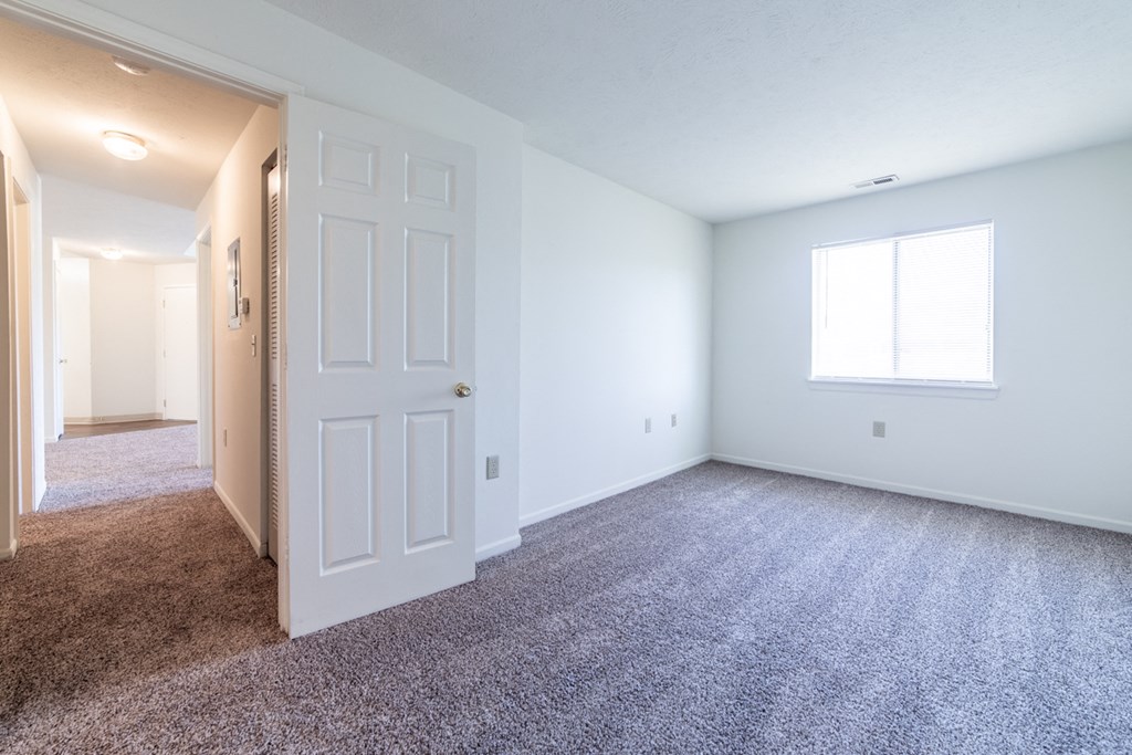 Bedroom with window and hallway at Bradford Run in Kokomo, IN