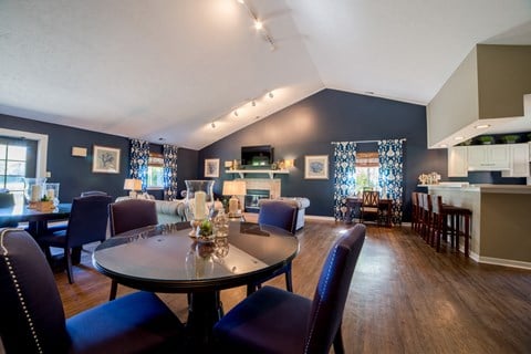 a living room and dining room with blue walls and a table