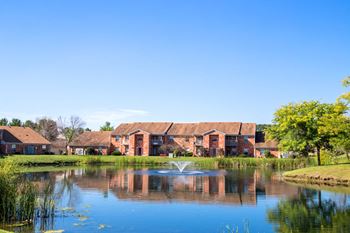 lake view with fountain and green space