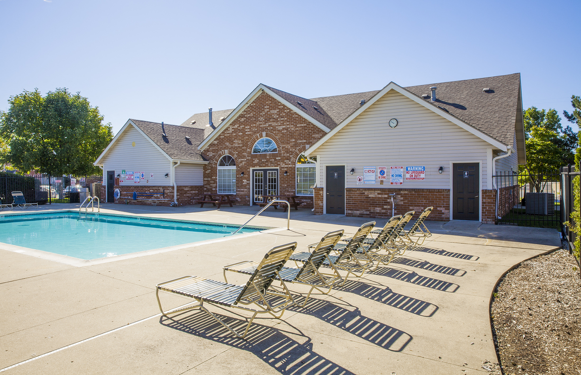 swimming pool and sundeck with lounge chairs