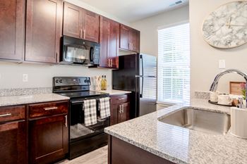 Kitchen with cabinets and appliances at Providence at Old Meridian Apartments , Carmel, 46032