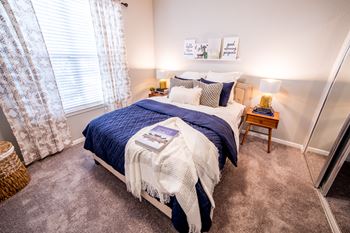 Bedroom with cozy bed and window at Providence at Old Meridian Apartments , Carmel