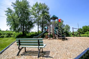 bench in outdoor park with playground
