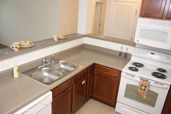 kitchen in apartment with white appliances  