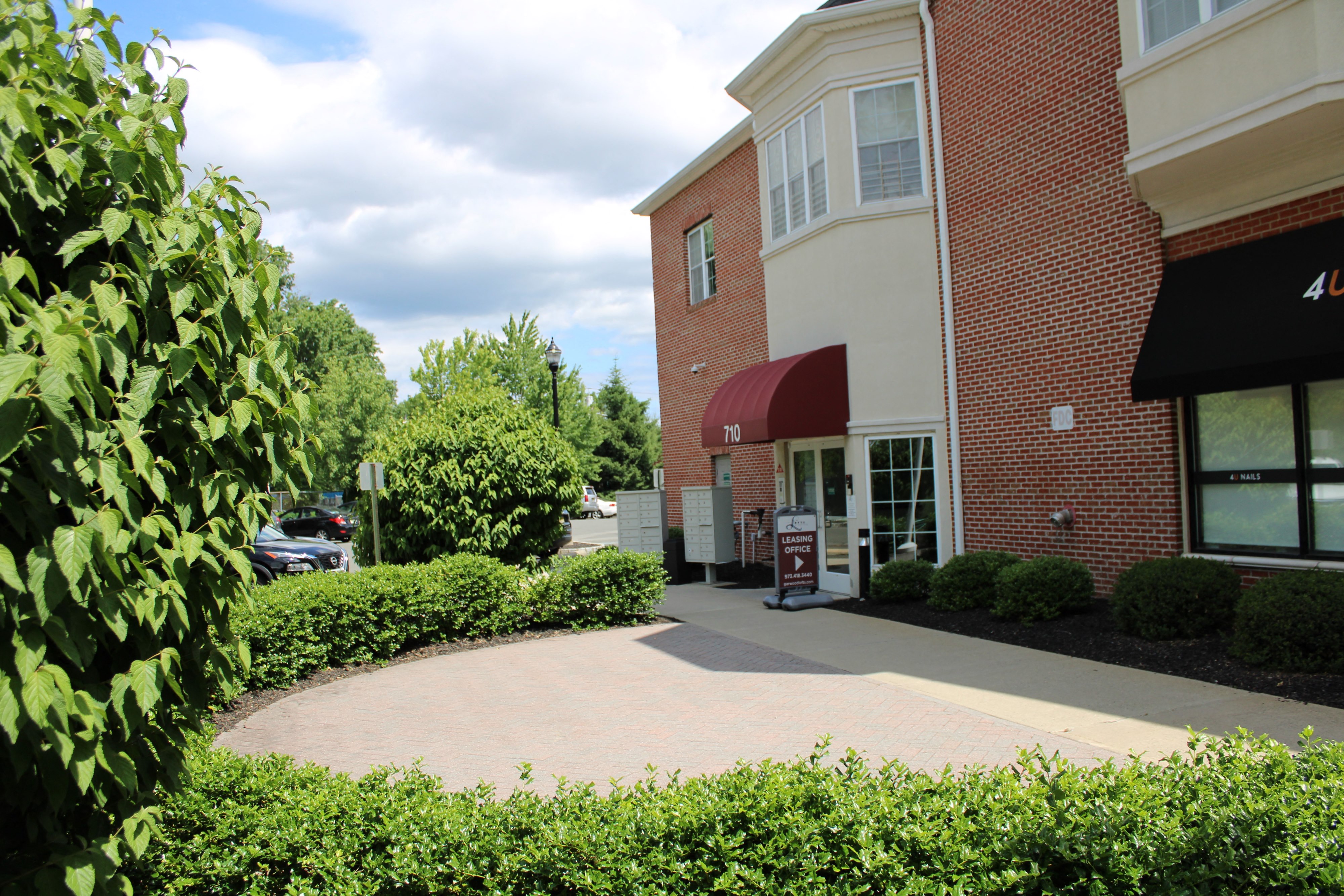 a brick building with a sidewalk in front of it