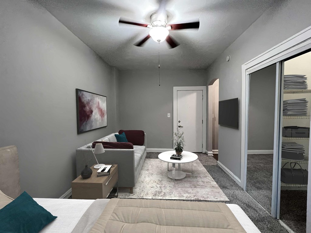 a living room with a ceiling fan and a couch