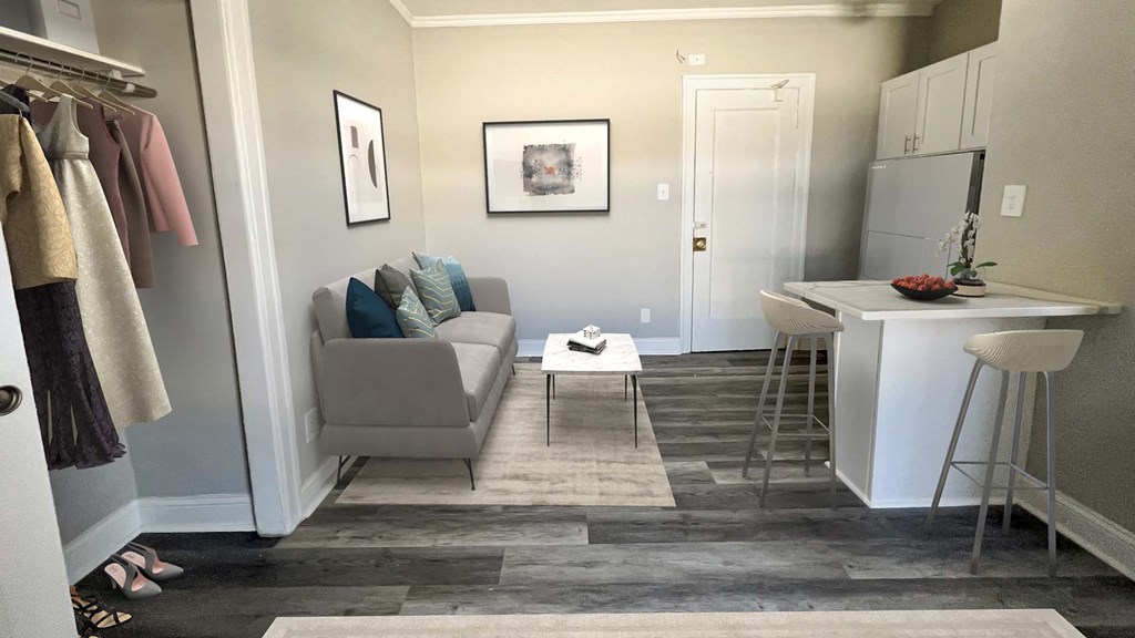 a small living room with a couch and a kitchen