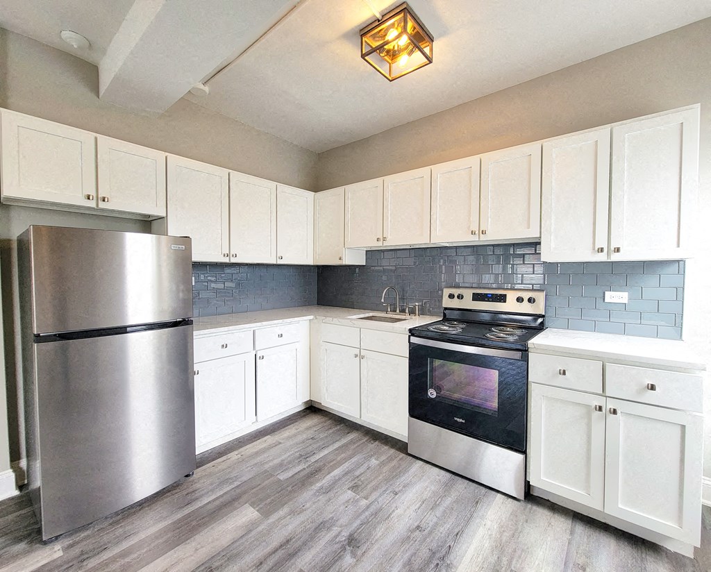 a kitchen with stainless steel appliances and white cabinets