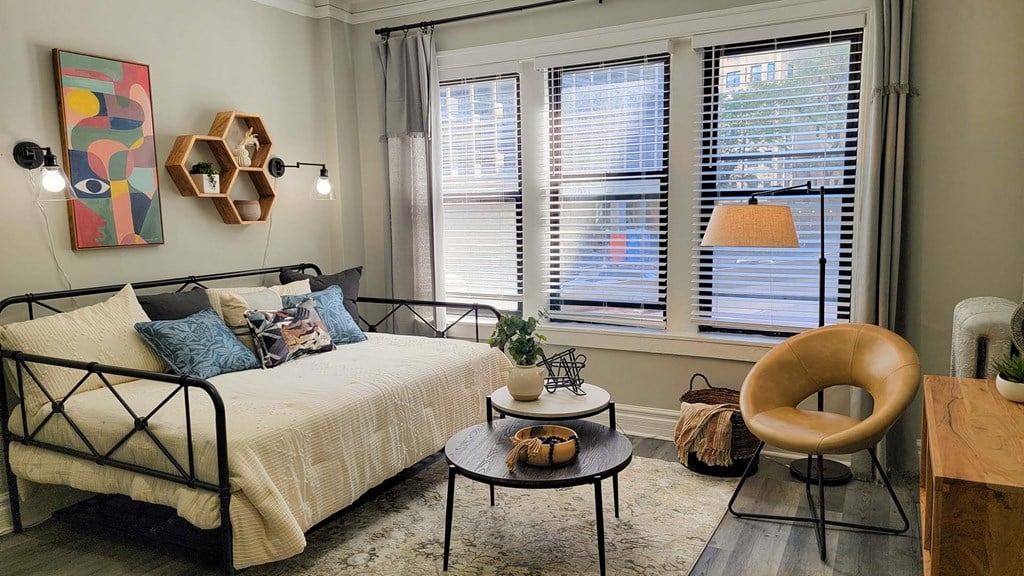 a bedroom with a bed and some windows