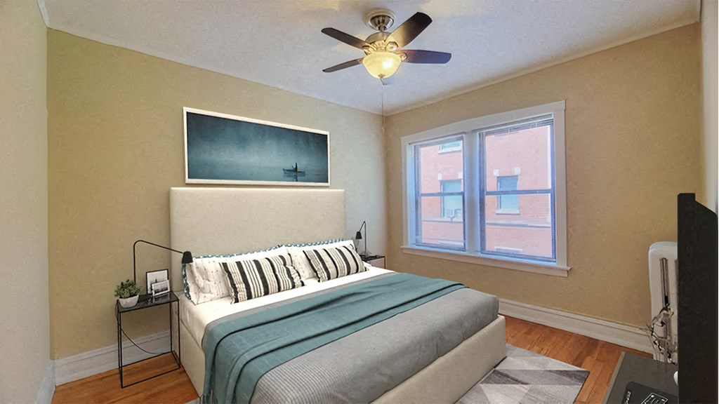 a bedroom with a bed and a ceiling fan
