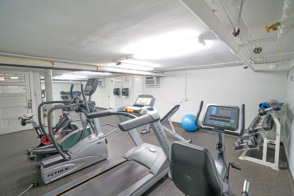 a gym with various pieces of equipment in a room