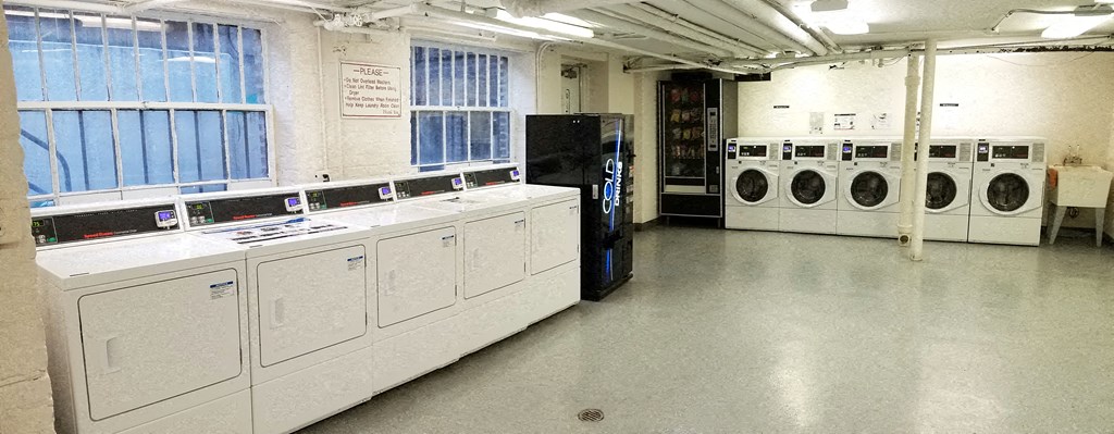a laundry room with a bunch of washers and dryers