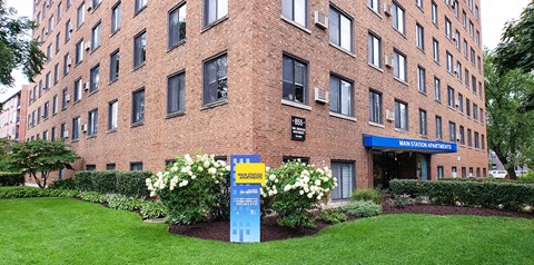 a large brick building with a sign in front of it