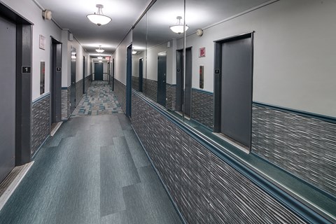 a long hallway with doors in a building