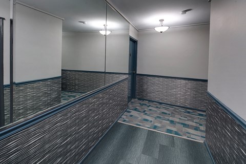 a mirrored wall in a room with a door