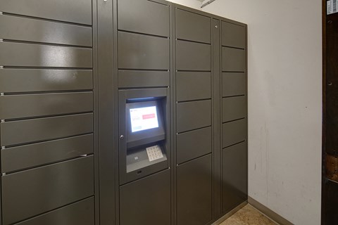 an automated teller machine in a wall of lockers