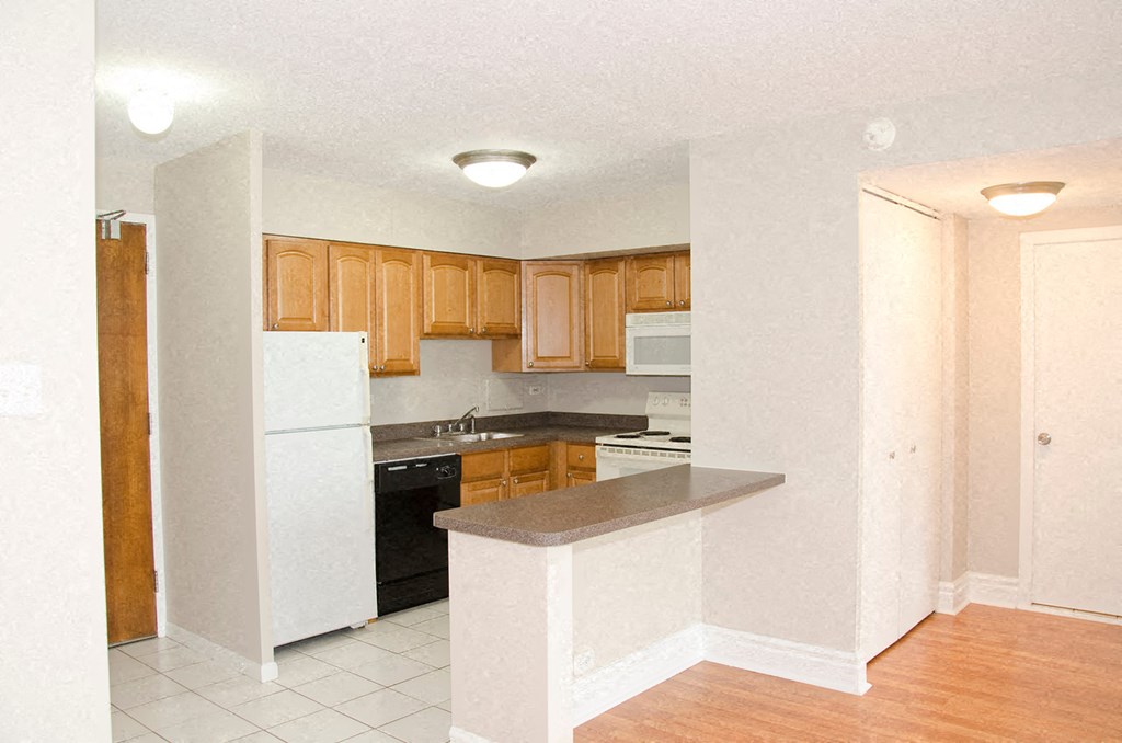 an empty kitchen with a stove and a refrigerator