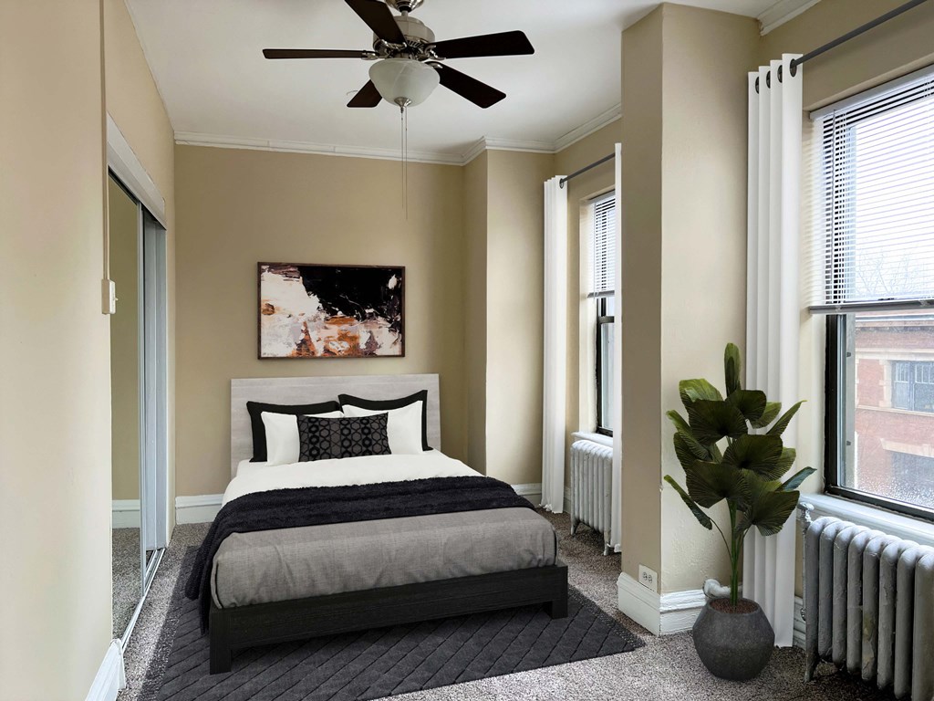 a bedroom with a bed and a ceiling fan