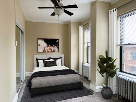 a bedroom with a bed and a ceiling fan