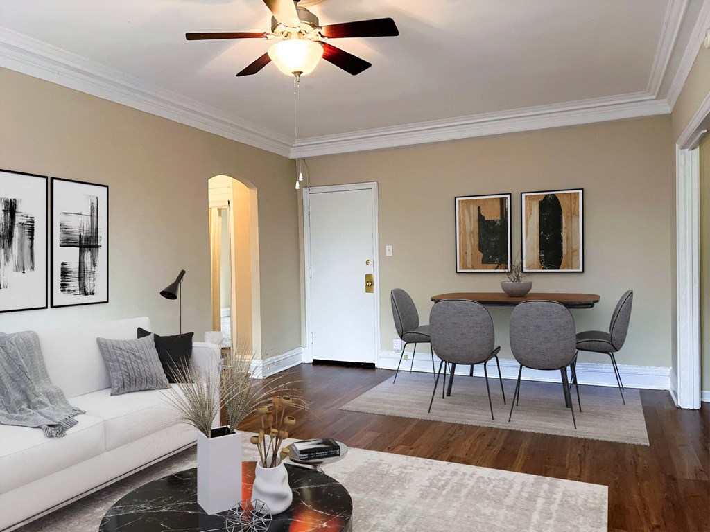 a living room with a dining room table and a ceiling fan