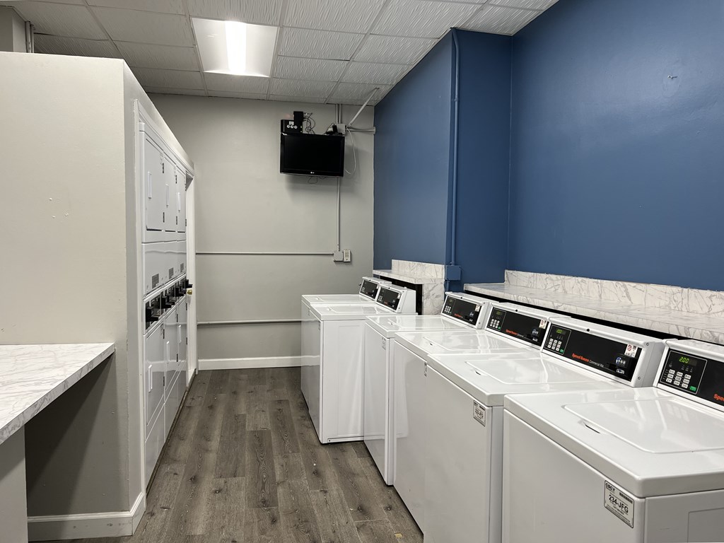A laundry room with washers and dryers.