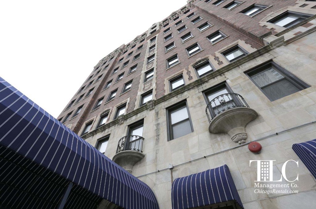 A tall building with a balcony on the 10th floor.