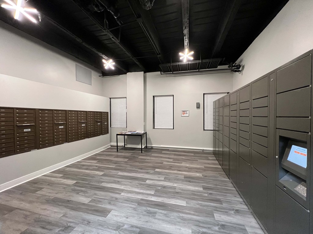A room with a grey floor and a black ceiling with lights.