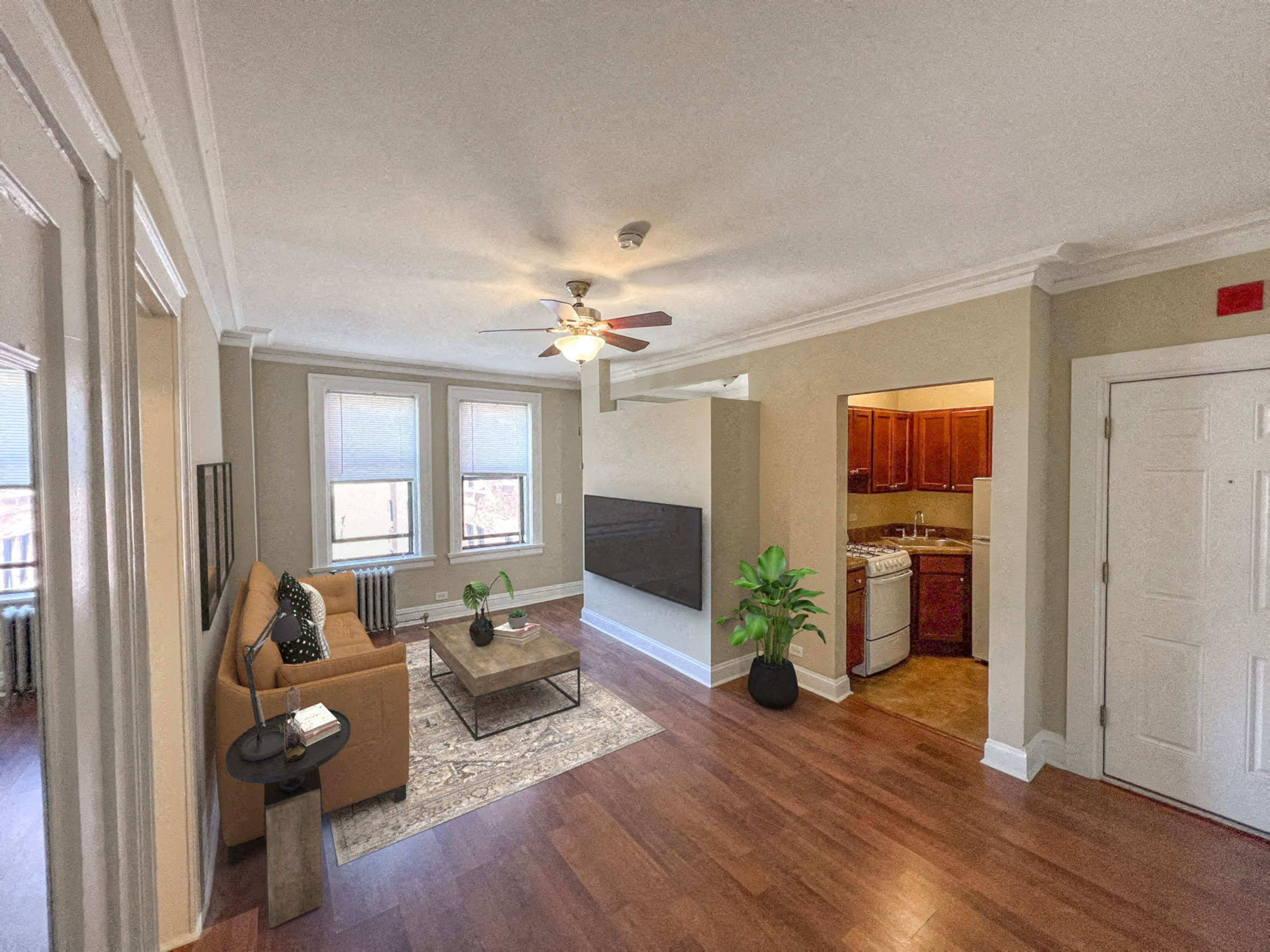 a living room with a couch and a ceiling fan
