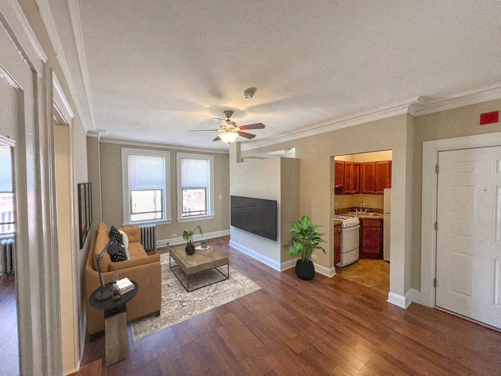 a living room with a couch and a ceiling fan