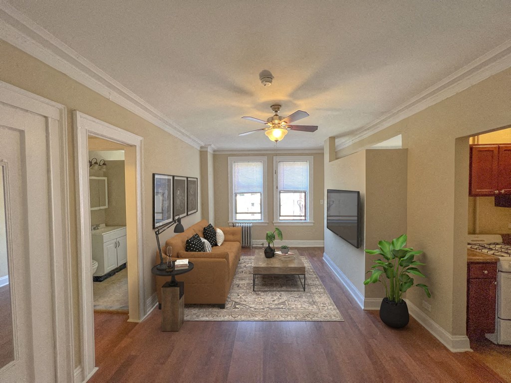a living room with a couch and a ceiling fan