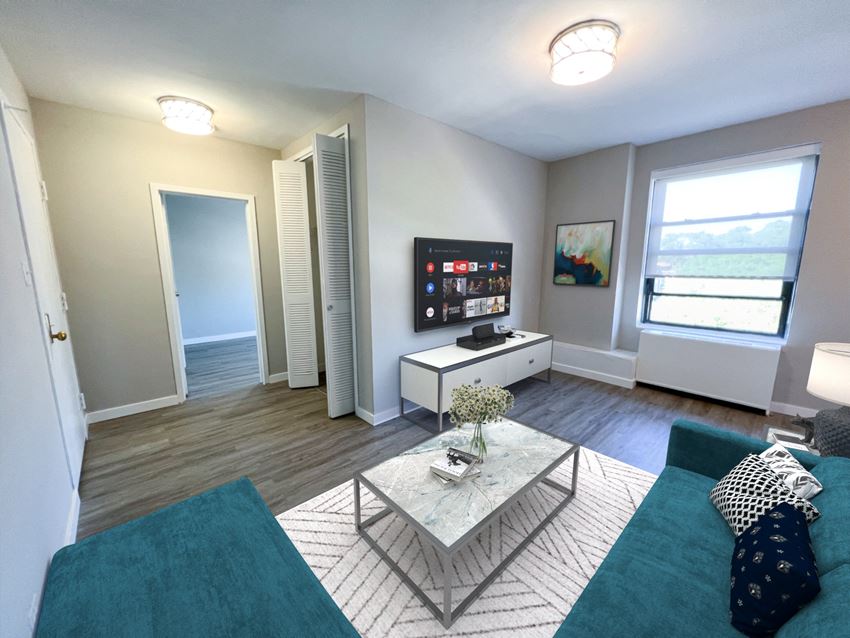 a living room with a blue couch and a white coffee table