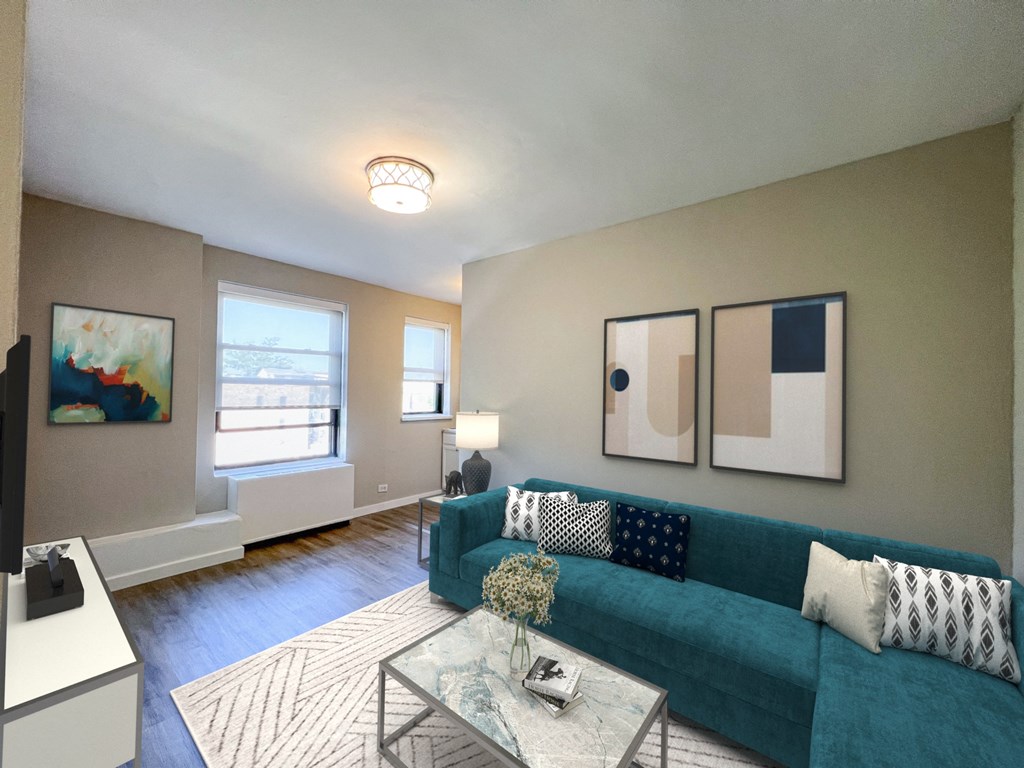 a living room with a blue couch and a glass coffee table
