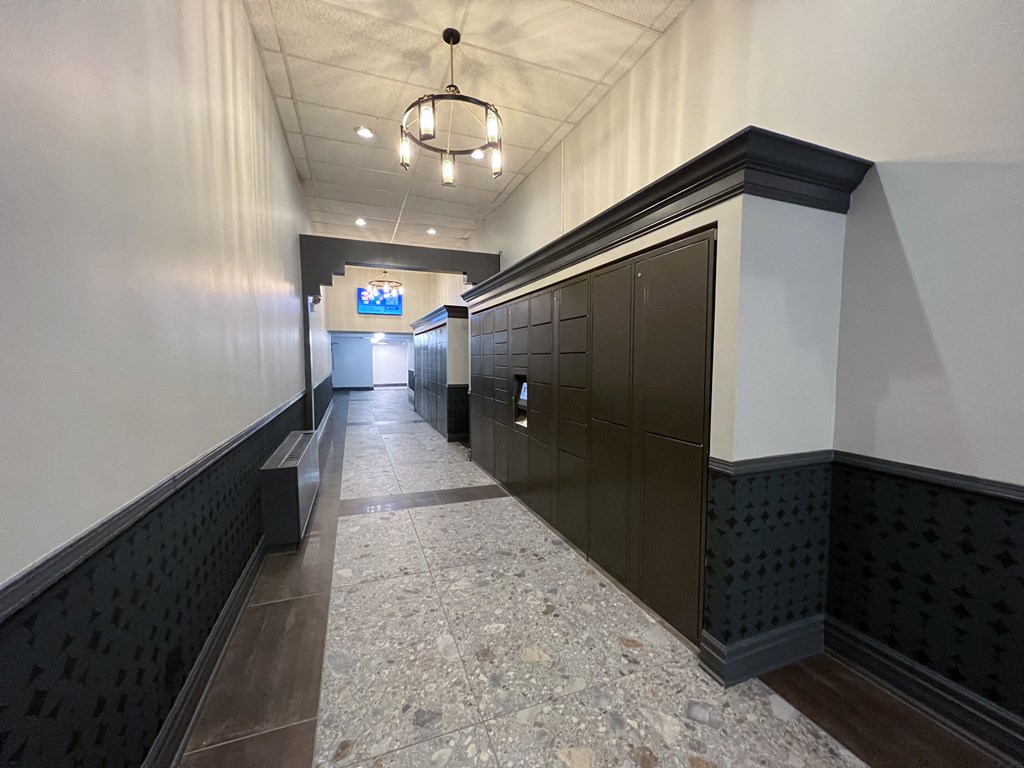 a long hallway with dark wood cabinets and a tile floor
