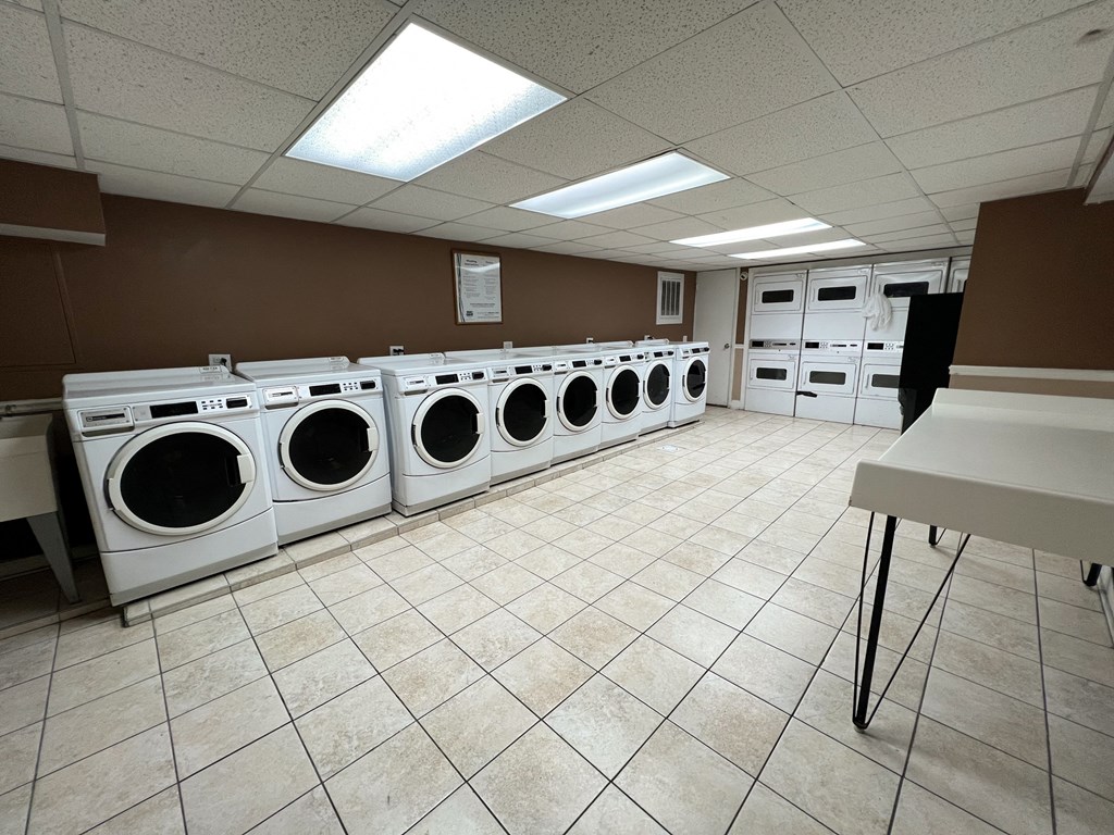 a group of washers and dryers in a laundry room