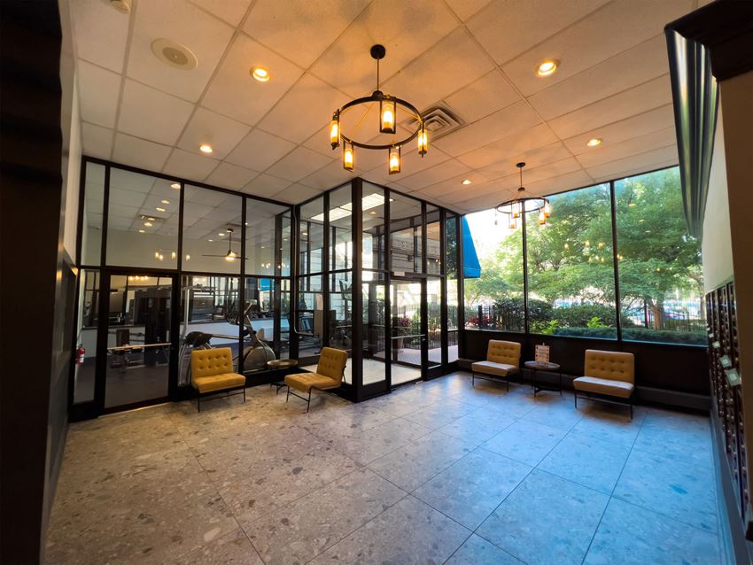 a lobby with yellow chairs and large windows