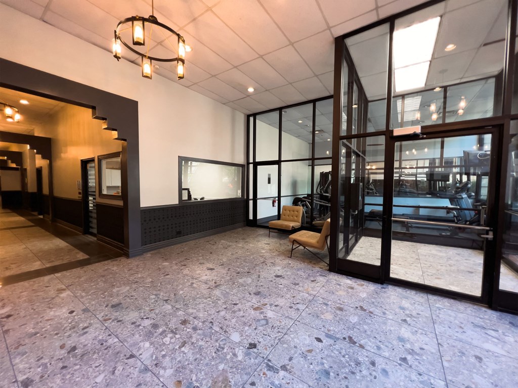an empty lobby with a pool in the corner of a building