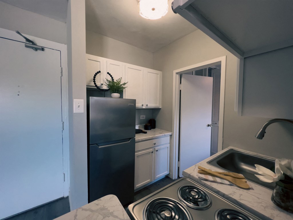 a kitchen with a sink and a refrigerator