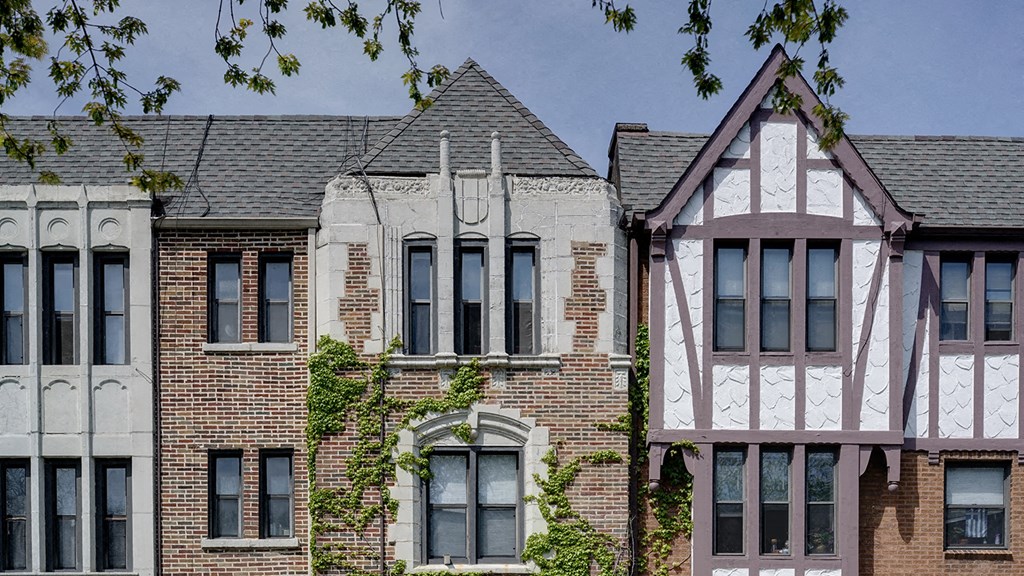 a row of houses in front of a blue sky