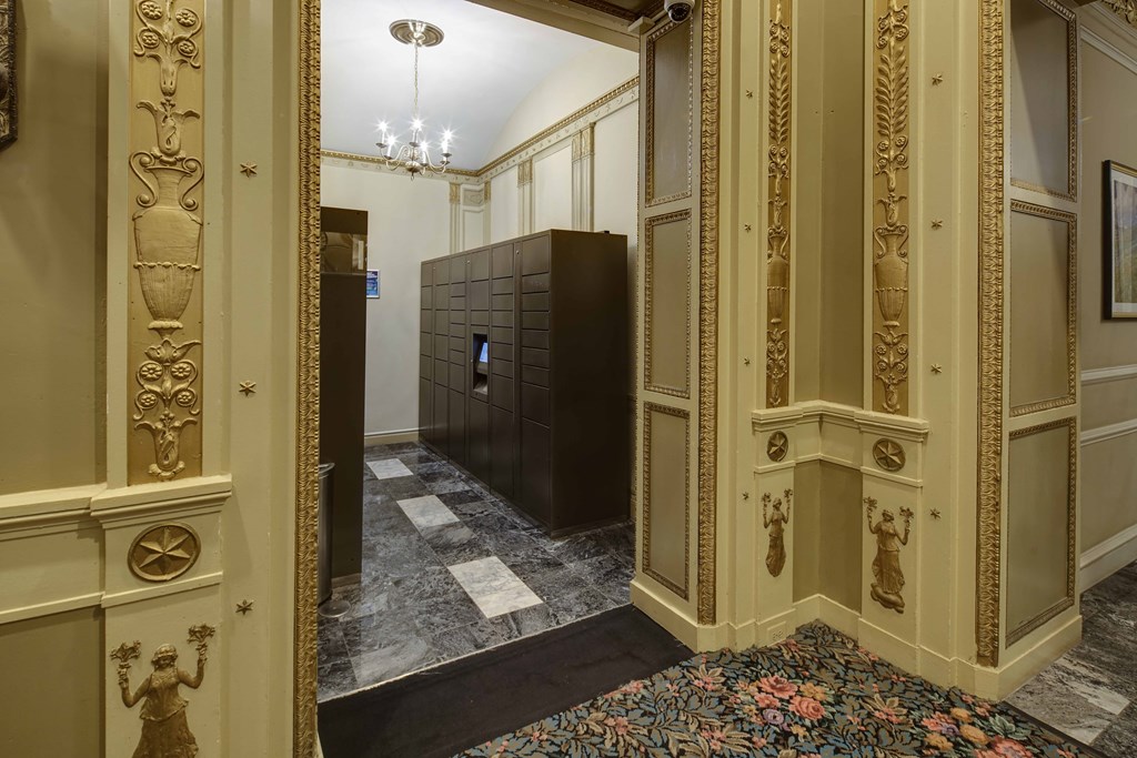 the lobby of a building with gold walls and a black door