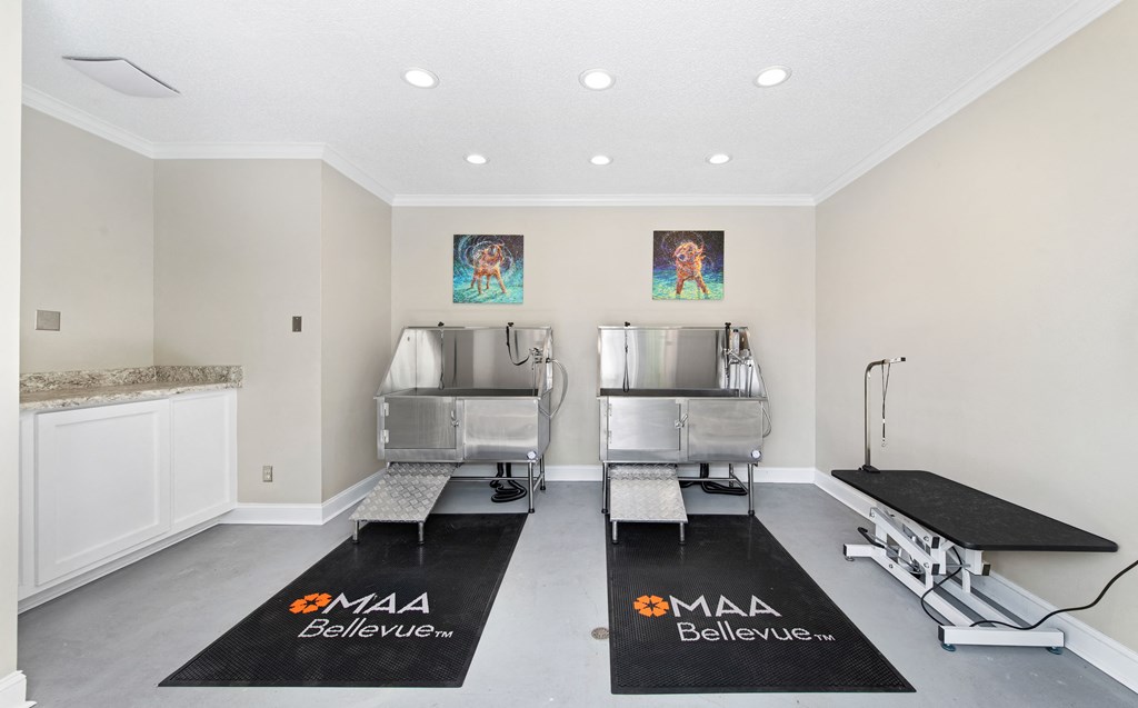 a workout room with two stainless steel machines and yoga mats