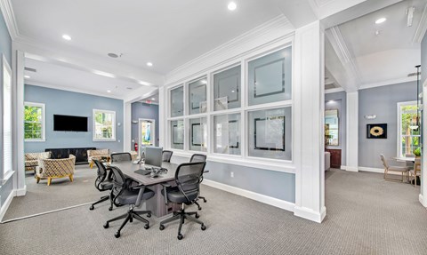a conference room with a table and chairs and a wall of windows